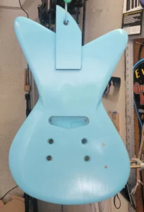 Guitar back painted with background blue. Next is to add paint design